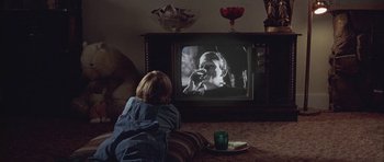 Movie still from “Gods and Monsters” (1998), directed by Bill Condon – A little girl sitting in front of an old tv; Medium shot, Over the shoulder angle