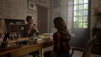Movie still from “Emily in Paris” (2020), created by Darren Star – A woman sitting at a table talking to a young girl; Medium shot, Over the shoulder angle