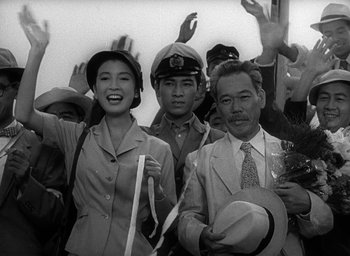 Movie still from “Godzilla” (1954), directed by Ishirô Honda – A group of people standing next to each other; Medium shot, High angle