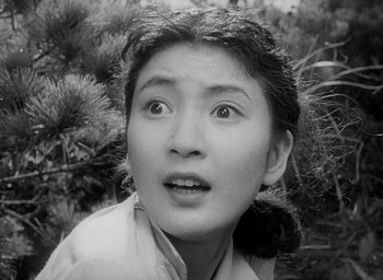 Movie still from “Godzilla” (1954), directed by Ishirô Honda – An asian woman with a surprised look on her face; Close Up shot, High angle