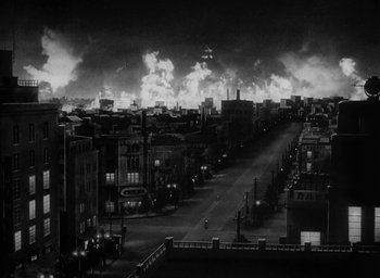 Movie still from “Godzilla” (1954), directed by Ishirô Honda – A black - and - white photo of a city at night; Extreme Wide shot, High angle