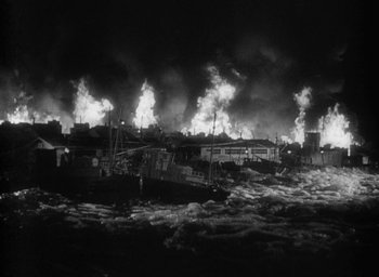Movie still from “Godzilla” (1954), directed by Ishirô Honda – A black - and - white photo of a boat in the ocean; Extreme Wide shot, High angle