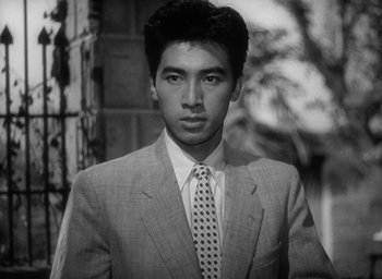 Movie still from “Godzilla” (1954), directed by Ishirô Honda – Black and white photograph of a man wearing a suit and tie; Close Up shot, Low angle