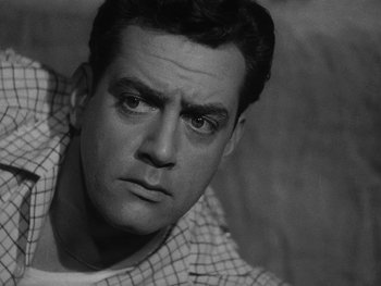 Movie still from “Godzilla: King of the Monsters!” (1956), directed by Ishirô Honda – Black and white photograph of a man in a checkered shirt; Close Up shot, Low angle