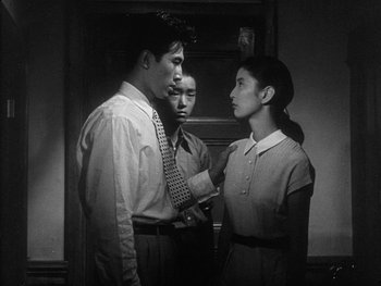 Movie still from “Godzilla: King of the Monsters!” (1956), directed by Ishirô Honda – A group of people standing next to each other in a room; Medium shot, Low angle