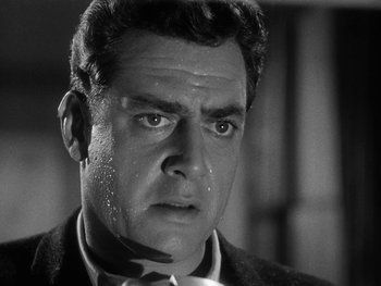 Movie still from “Godzilla: King of the Monsters!” (1956), directed by Ishirô Honda – A man in a suit and tie looking at the camera; Close Up shot, Low angle