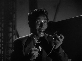 Movie still from “Godzilla: King of the Monsters!” (1956), directed by Ishirô Honda – An old man holding a phone in his hands; Close Up shot, Low angle