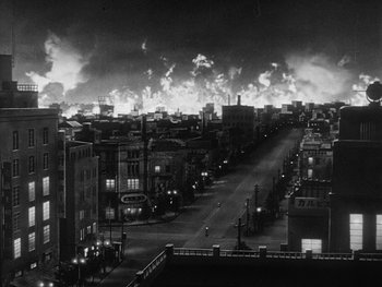Movie still from “Godzilla: King of the Monsters!” (1956), directed by Ishirô Honda – A black - and - white photo of a city at night; Extreme Wide shot, High angle