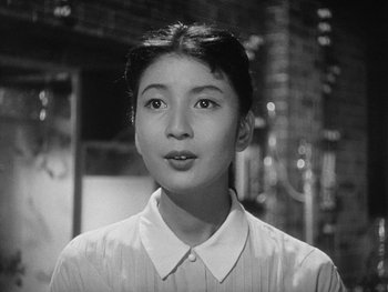 Movie still from “Godzilla: King of the Monsters!” (1956), directed by Ishirô Honda – An asian woman in a white dress shirt; Close Up shot, Low angle