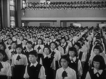 Movie still from “Godzilla: King of the Monsters!” (1956), directed by Ishirô Honda – A large group of people in a room; Extreme Wide shot, High angle