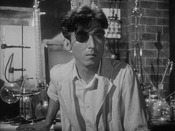 Movie still from “Godzilla: King of the Monsters!” (1956), directed by Ishirô Honda – A young man wearing an eyepatch in a room; Close Up shot, Low angle