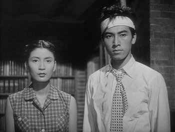 Movie still from “Godzilla: King of the Monsters!” (1956), directed by Ishirô Honda – A man and a woman standing next to each other; Medium shot, Low angle