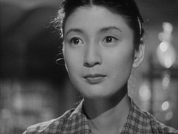 Movie still from “Godzilla: King of the Monsters!” (1956), directed by Ishirô Honda – A black - and - white photo of a young woman; Close Up shot, Low angle