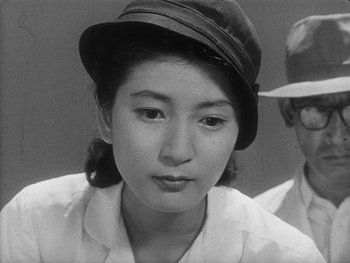 Movie still from “Godzilla: King of the Monsters!” (1956), directed by Ishirô Honda – An old photo of a woman wearing a hat; Close Up shot, High angle