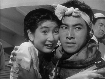 Movie still from “Godzilla: King of the Monsters!” (1956), directed by Ishirô Honda – An asian man and a japanese woman pose for a picture; Close Up shot, Low angle
