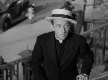 Movie still from “Going My Way” (1944), directed by Leo McCarey – A black and white photo of a man wearing a hat; Medium shot, High angle