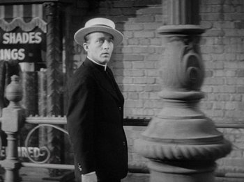 Movie still from “Going My Way” (1944), directed by Leo McCarey – A black and white photo of a man wearing a hat; Medium shot, Over the shoulder angle