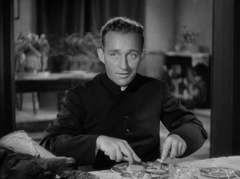 Movie still from “Going My Way” (1944), directed by Leo McCarey – A man sitting at a table with a plate in front of him; Close Up shot, Low angle