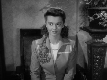 Movie still from “Going My Way” (1944), directed by Leo McCarey – A black - and - white photo of a woman in a suit; Close Up shot, High angle