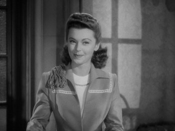 Movie still from “Going My Way” (1944), directed by Leo McCarey – A black - and - white photo of a woman in a suit; Close Up shot, Low angle