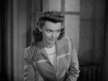 Movie still from “Going My Way” (1944), directed by Leo McCarey – A black - and - white photo of a woman in a jacket; Close Up shot, High angle