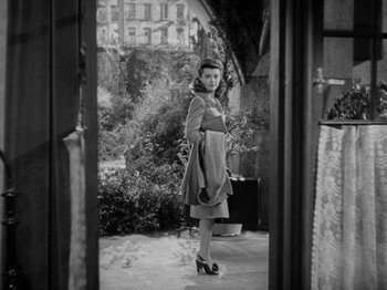 Movie still from “Going My Way” (1944), directed by Leo McCarey – A woman standing in front of an open door; Wide shot, High angle