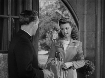 Movie still from “Going My Way” (1944), directed by Leo McCarey – A man and a woman standing next to each other; Medium shot, Over the shoulder angle