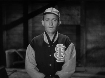 Movie still from “Going My Way” (1944), directed by Leo McCarey – An old photo of a baseball player in a uniform; Close Up shot, High angle