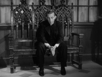 Movie still from “Going My Way” (1944), directed by Leo McCarey – A black and white photo of a man sitting on a bench; Medium shot, High angle