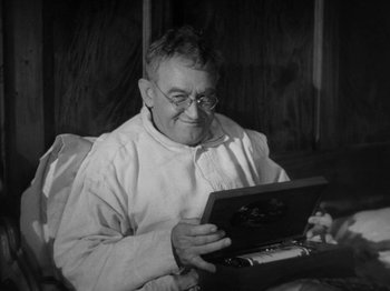 Movie still from “Going My Way” (1944), directed by Leo McCarey – An old man sitting in front of an open laptop computer; Close Up shot, High angle