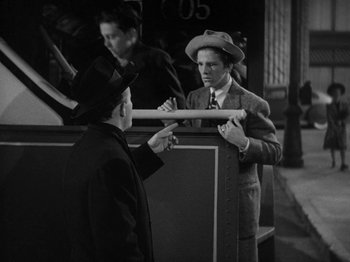 Movie still from “Going My Way” (1944), directed by Leo McCarey – Two men in suits and hats talking to each other; Medium shot, High angle
