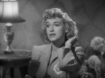 Movie still from “Going My Way” (1944), directed by Leo McCarey – A black - and - white photo of a woman brushing her hair; Close Up shot, High angle