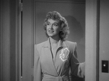 Movie still from “Going My Way” (1944), directed by Leo McCarey – A black - and - white photo of a woman in a suit; Medium shot, Low angle