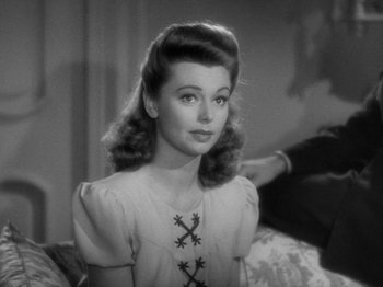 Movie still from “Going My Way” (1944), directed by Leo McCarey – A black - and - white photo of a woman in a white dress; Close Up shot, Over the shoulder angle