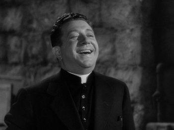 Movie still from “Going My Way” (1944), directed by Leo McCarey – A man in a priest's outfit smiling for the camera; Close Up shot, Low angle
