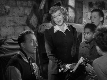 Movie still from “Going My Way” (1944), directed by Leo McCarey – A group of people standing next to each other in a room; Medium shot, High angle