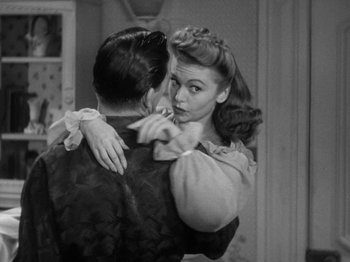 Movie still from “Going My Way” (1944), directed by Leo McCarey – A man and a woman embracing each other in front of a mirror; Medium shot, Over the shoulder angle