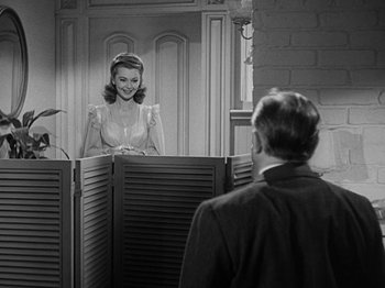 Movie still from “Going My Way” (1944), directed by Leo McCarey – A man and a woman in front of a mirror; Medium shot, Over the shoulder angle