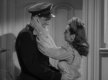 Movie still from “Going My Way” (1944), directed by Leo McCarey – A man and a woman are hugging each other; Medium shot, High angle