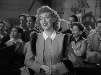 Movie still from “Going My Way” (1944), directed by Leo McCarey – A black - and - white photo of a woman singing; Medium shot, Low angle