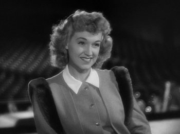 Movie still from “Going My Way” (1944), directed by Leo McCarey – An old photo of a woman in a suit; Close Up shot, High angle
