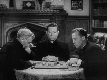 Movie still from “Going My Way” (1944), directed by Leo McCarey – A group of men sitting at a table playing a game of chess; Medium shot, High angle