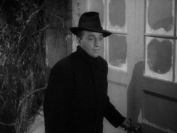Movie still from “Going My Way” (1944), directed by Leo McCarey – A man wearing a hat and a black coat; Close Up shot, Low angle
