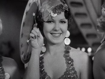 Movie still from “Gold Diggers of 1933” (1933), directed by Mervyn LeRoy – A woman in a sequined dress holding a parasol; Close Up shot, Low angle