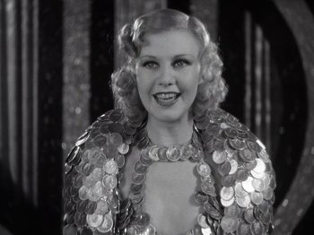 Movie still from “Gold Diggers of 1933” (1933), directed by Mervyn LeRoy – A black and white photo of a woman in a sequined dress; Close Up shot, Low angle