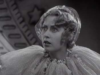 Movie still from “Gold Diggers of 1933” (1933), directed by Mervyn LeRoy – An old photo of a woman wearing a veil; Close Up shot, Low angle