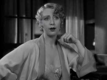 Movie still from “Gold Diggers of 1933” (1933), directed by Mervyn LeRoy – An old photo of a woman in a white dress; Close Up shot, High angle