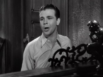 Movie still from “Gold Diggers of 1933” (1933), directed by Mervyn LeRoy – A young man is standing in front of a mirror; Close Up shot, Low angle