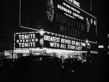 Movie still from “Gold Diggers of 1933” (1933), directed by Mervyn LeRoy – A black - and - white photo of a theater marquee; Extreme Wide shot, High angle