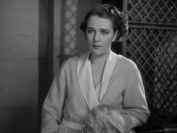 Movie still from “Gold Diggers of 1933” (1933), directed by Mervyn LeRoy – An old photo of a woman in a robe holding a child; Close Up shot, High angle